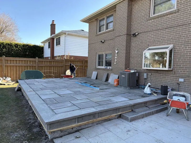 Backyard stone patio off the house