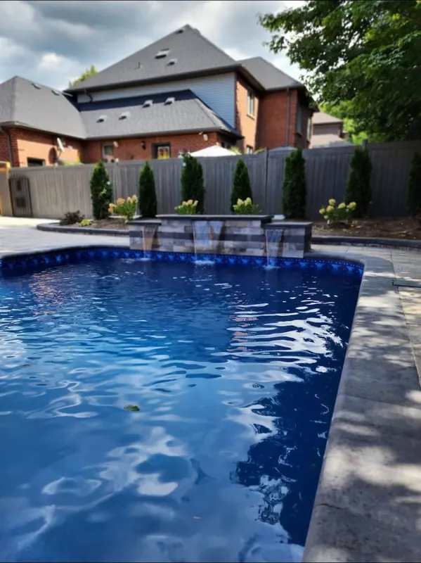 Pool with stone deck and waterfall feature