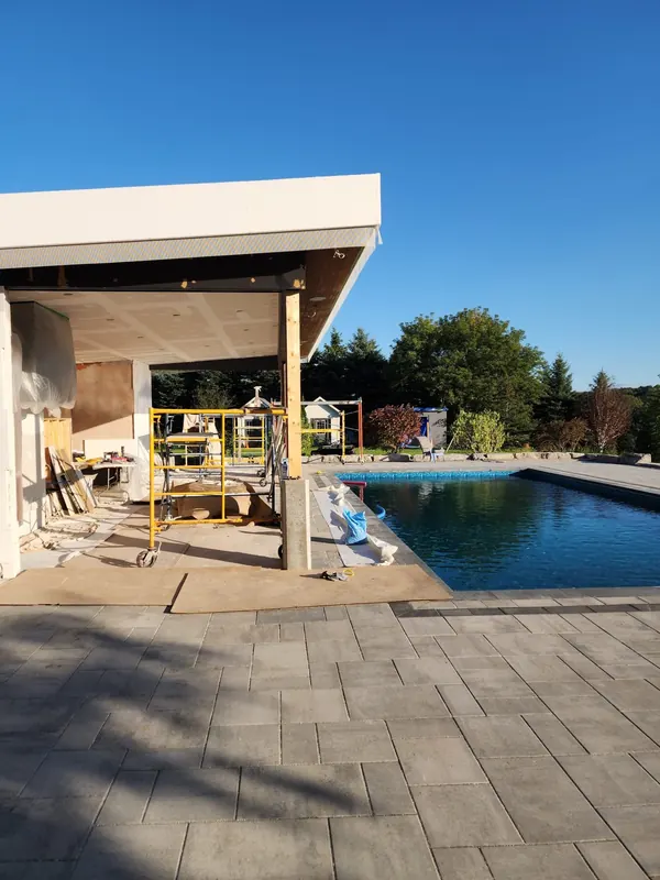 Pool with paver patio and pergola